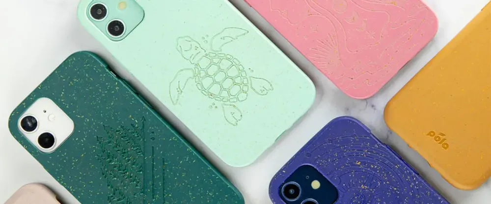 Several colors of Pela phone case on a white marble background